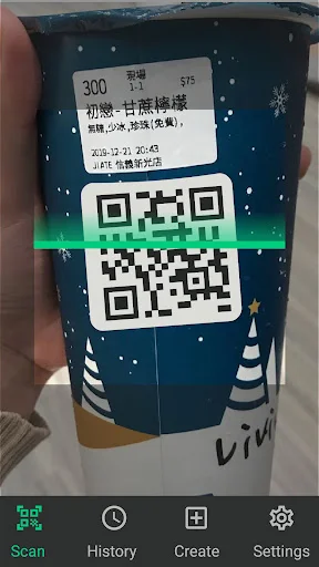 QR code scanner app actively scanning multiple QR codes on product box in real-world setting with Scan History Create Settings menu